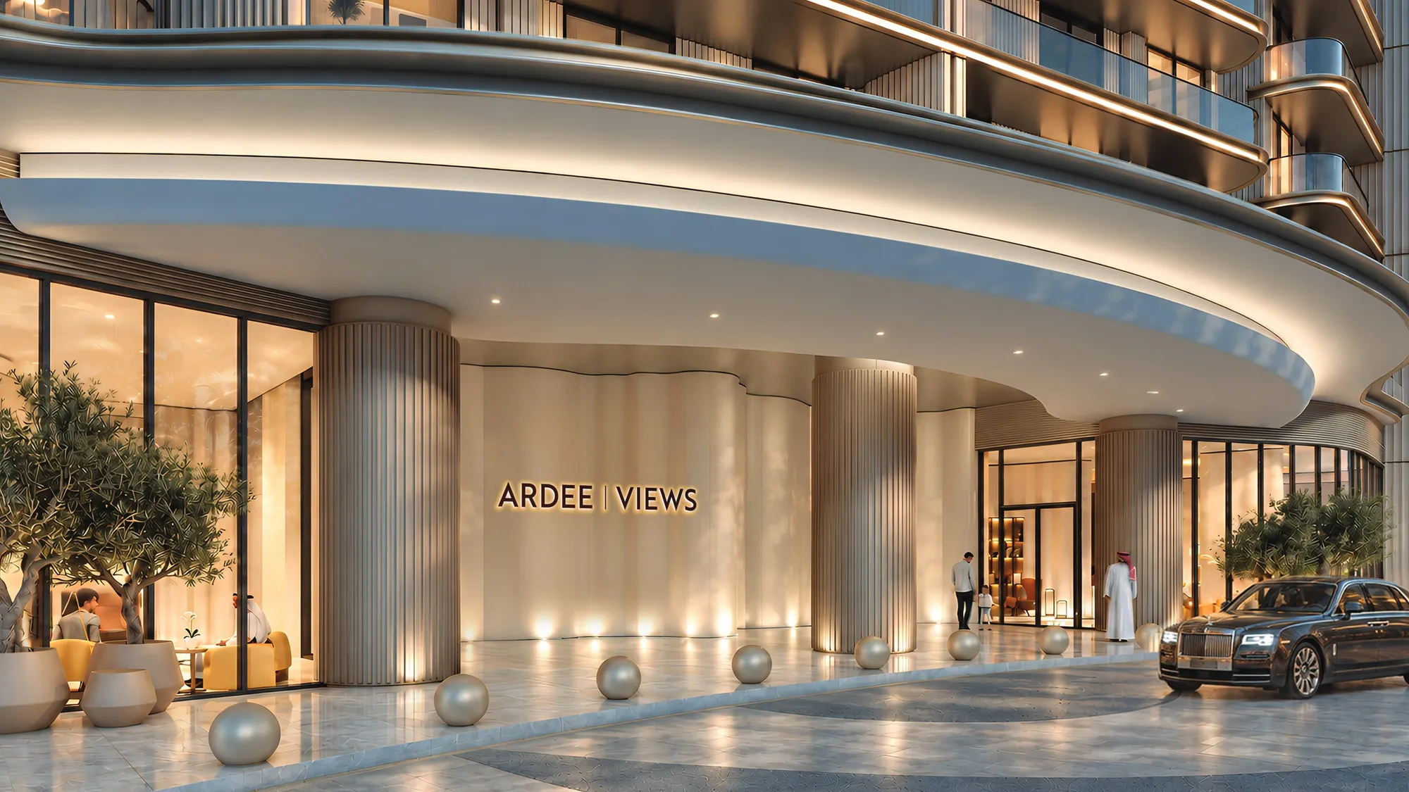 Curved, softly lit entrance canopy of Ardee Views with a car at the door